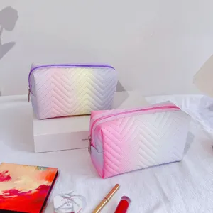 Detail view of the gradient cosmetic bag, chevron quilted design, portable storage pouch.