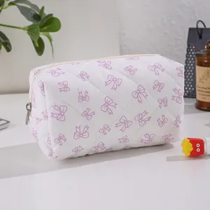 Pink quilted bow cosmetic bag, portable large capacity storage pouch for daily travel.