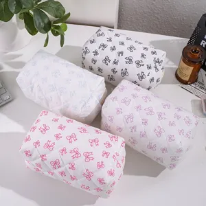 Detailed close-up view of quilted cosmetic storage bags featuring charming bow print patterns.
