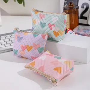 Detail view of cute heart quilted leather coin purse, portable makeup pouch and mini card holder.