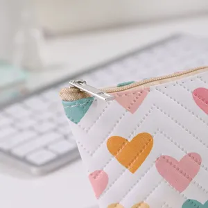 Cute faux leather coin purse detail featuring colorful heart prints and neat stitching lines.