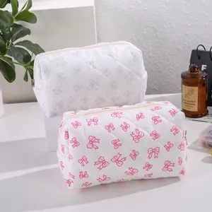 Quilted cosmetic bag set with cute bow print, large capacity portable makeup storage pouch.