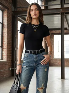 Detailed view of women retro suede belt with square buckle paired with stylish denim jeans.
