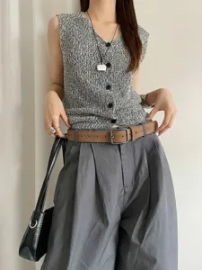 Retro suede belt detail shot featuring square metal buckle and chic women apparel styling.