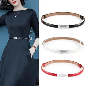 Women's thin patent leather dress belt with silver buckle, stylish waist accessory for suits.