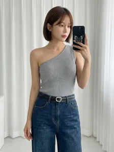 Detail shot showing stylish grey one-shoulder ribbed tank top paired with denim jeans and belt.
