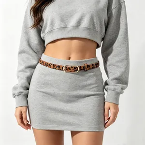 Close-up detail of the stylish leopard print thin leather belt featuring a gold metal buckle.