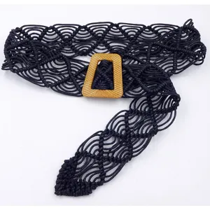 Close up view of the black macrame woven belt showing intricate knot patterns and textured buckle.