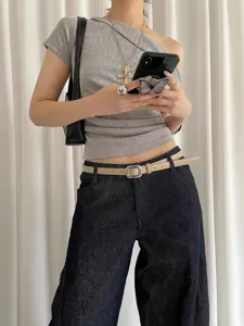 Stylish minimalist thin double belt with square silver buckle paired with denim jeans.
