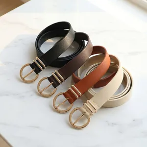 Women's golden buckle faux leather belt, stylish decorative accessory for jeans and dresses.