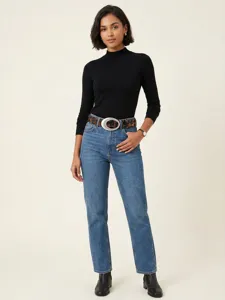 Detailansicht eines Retro-Leopardenmustergürtels mit großer ovaler Schnalle am Model.