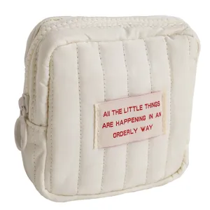 Mini quilted cosmetic bag, portable storage pouch for makeup, lipstick and travel essentials.