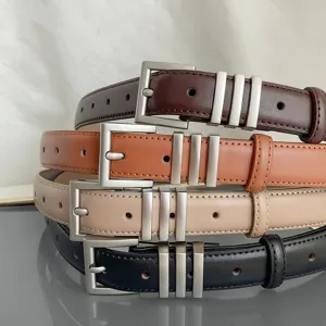 Close-up detail of stacked women leather belts with metallic silver buckles and stylish loops.