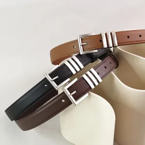 Detail shot of three stylish women's leather belts with silver pin buckles and loops.