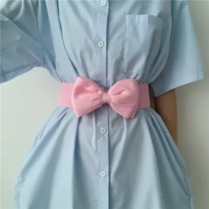 Pink bow waist belt detail shot, wide elastic stretch cincher accessory for dresses.