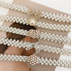 Detailed view displaying multiple elegant pearl waist belts with diverse decorative buckles.