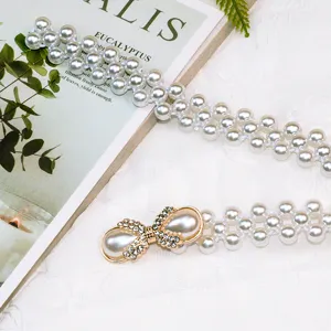 Pearl belt detail featuring multi-strand beaded design with elegant rhinestone buckle.