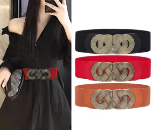 Women's vintage elastic wide waist belt with ornate metal buckle for dresses and coats.