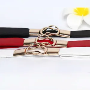 Elastic thin waist belt detail showing black, red and white colors with gold metal buckle.