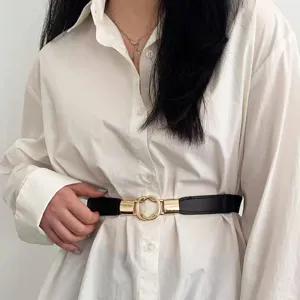 Stylish elastic waist belt for women, black stretch band with gold ring buckle detail.