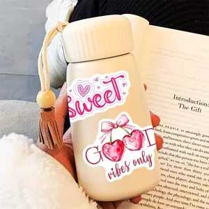 Portable pink insulated water bottle with cute English quote stickers and wooden bead strap.