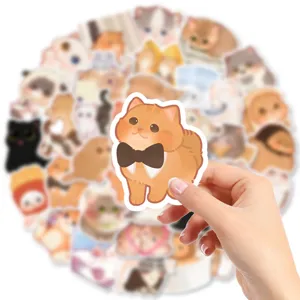 Cute cat stickers detail showing a hand holding an orange cat decal, waterproof vinyl design.