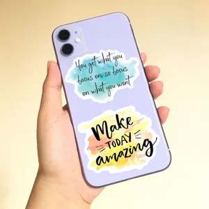 Detail view of colorful watercolor inspirational quote stickers applied on phone case back.