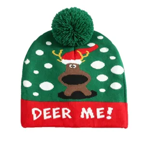 Weihnachtliche Strickmütze mit grünem Bommel, süßem Renntier-Design und warmer Winterstil.