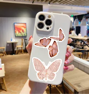 White phone case with vintage pink butterfly newspaper stickers, stylish protective cover.