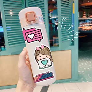 Detailed view of cute cartoon sticker decorations on a portable thermos bottle in daily use.