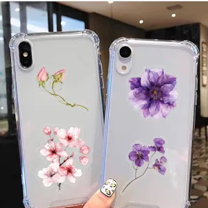 Detailed view of transparent phone cases decorated with beautiful floral stickers for daily DIY use.
