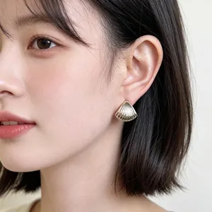 Gold shell stud earrings for women, elegant geometric metal ear jewelry for daily wear.