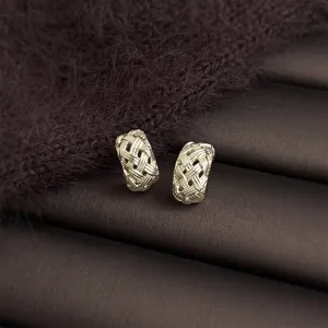 Detailed view of elegant woven metal hoop earrings, exquisite texture and stylish design.