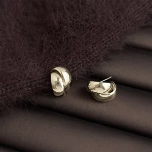 Close up of coffee gold geometric water drop earrings, smooth finish, elegant daily jewelry.