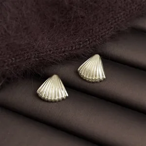 Detailed view of chic gold shell geometric earrings, elegant fashion jewelry for daily commute.