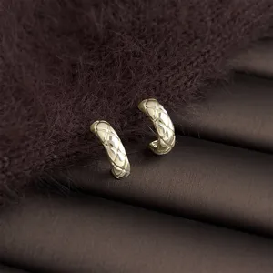 Detailed shot of luxury gold geometric quilted hoop earrings for women, chic and elegant.