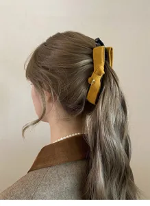 Detailed shot of retro velvet bow banana clip showcasing elegant hair styling and texture.