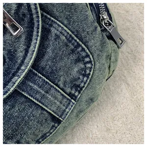 Retro denim shoulder bag detail, stylish motorcycle style metal hardware and spacious design.