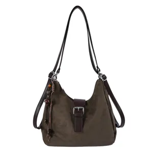 Close-up detail of the dark brown women's hobo backpack, showing buckle and tassel charm.