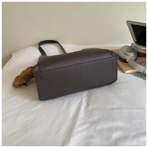 Dark brown textured leather shoulder bag detail view, casual chic daily handbag for women.