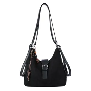 Detailed view of this casual black women's shoulder bag with front buckle and charm.