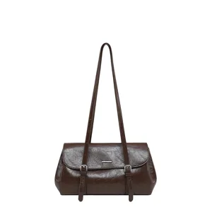 Brown minimalist shoulder bag, detailed view of texture and metal buckle. Ideal for daily commute.