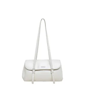 Elegant white shoulder bag detail showing delicate double straps and metal buckle design.
