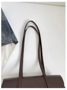 Brown shoulder bag detail shot minimalist aesthetic daily commute versatile axillary bag