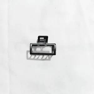 Minimalist metal hair claw clip detail shot, elegant geometric rectangle hair accessory for women.