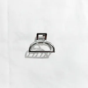 Detail view of minimalist silver alloy hair claw clip, elegant half-circle design.