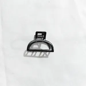Minimalist black metal hair claw clip for women, sleek half-circle design daily hair accessory.