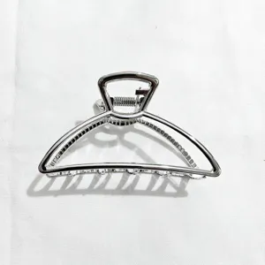 Silver metal hair claw clip detail, geometric openwork design for daily elegant styling.