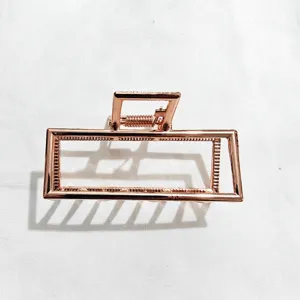 Rose gold geometric metal hair claw clip, stylish minimal hair accessory for daily styling.