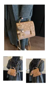 Detail view of stylish brown patterned backpack with cute teddy bear charm and pockets.